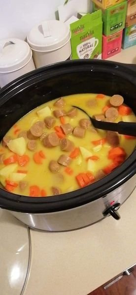 A delicious slow cooker curried sausage recipe. Here is a detailed recipe based on the image: Ingredients: 13 sausages 5 potatoes, cubed 4 carrots, peeled and chopped 1 cup of corn 1 can of coconut milk 2 tablespoons of curry powder 3 cups of chicken stock 2 tablespoons of cornflour Salt and pepper to taste Instructions: Parboil the sausages, then remove the skins and chop them into bite-sized pieces. In a slow cooker, combine the chopped sausages, potatoes, carrots, corn, coconut milk, curry powder, and chicken stock. Season with salt and pepper to taste. Cook on low for 5-6 hours, or until the vegetables are tender and the sausages are cooked through. If the sauce is too thin, thicken it with cornstarch slurry. To make cornstarch slurry, mix 2 tablespoons of cornstarch with a little bit of water until smooth. Then, slowly whisk the slurry into the slow cooker while it is on low heat. Let it simmer for a few minutes until the sauce thickens to your desired consistency. Serve over rice or mashed potatoes, and enjoy! Tips: You can use any type of sausage you like for this recipe. If you don't have coconut milk, you can use another type of milk or cream. You can also add other vegetables to this recipe, such as peas, celery, or green beans. For a spicier curry, add more curry powder or a chopped chili pepper.