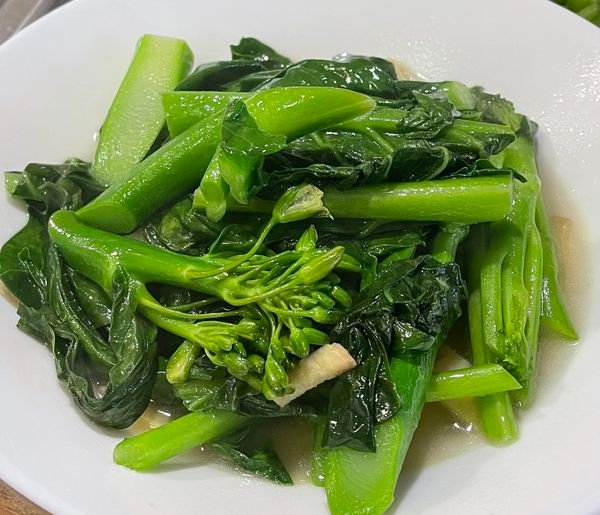 A plate of stir-fried broccoli with ginger