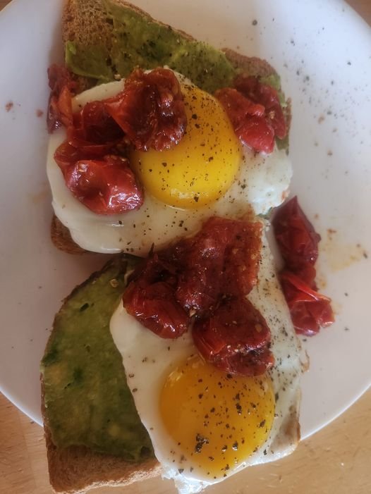 Avocado toast with fried eggs and roasted tomatoes